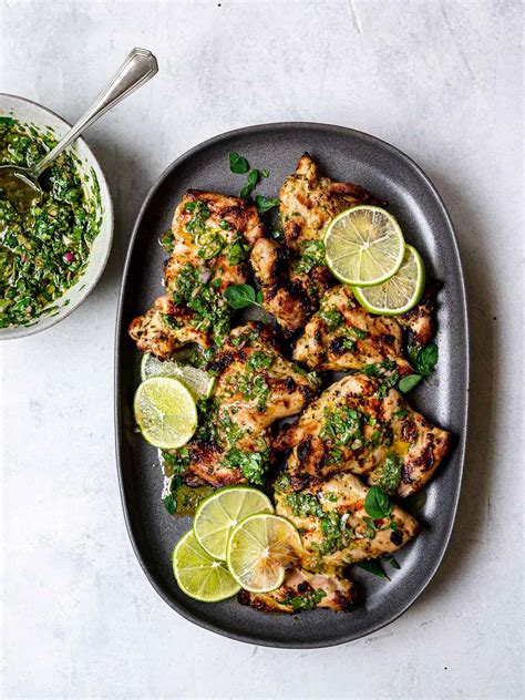 Chimichurri charcoal chicken - Learn how to grill a whole chicken with a Thai-inspired marinade and a herby chimichurri sauce. Follow the step-by-step instructions and tips from Marion's Kitchen and Firehawk Grills. 